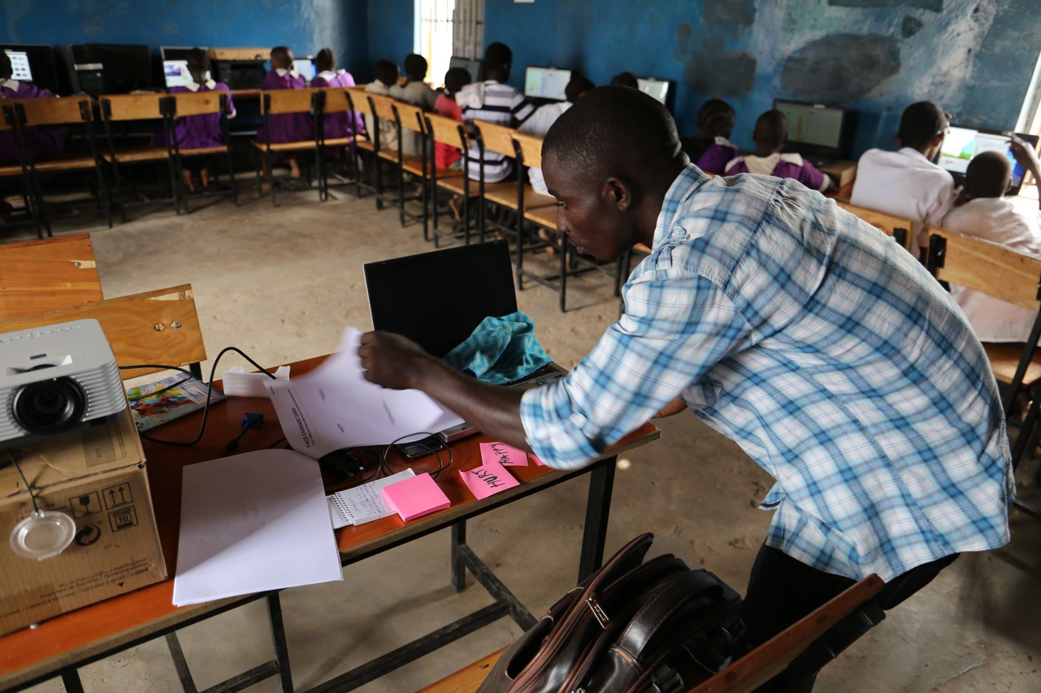 A teacher looks over notes during a class.